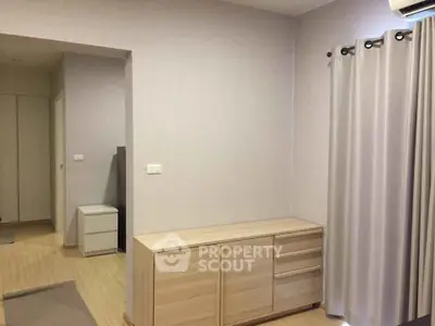 Modern minimalist bedroom with light wood furniture and neutral tones.