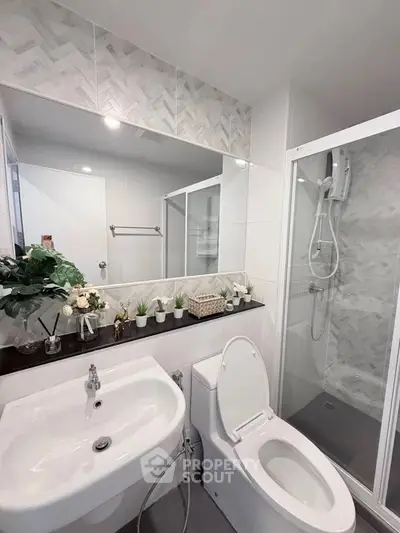 Modern bathroom with sleek shower and elegant decor, perfect for a contemporary home.
