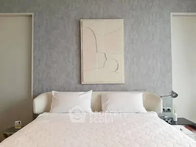 Elegant bedroom with modern decor and abstract art above the bed