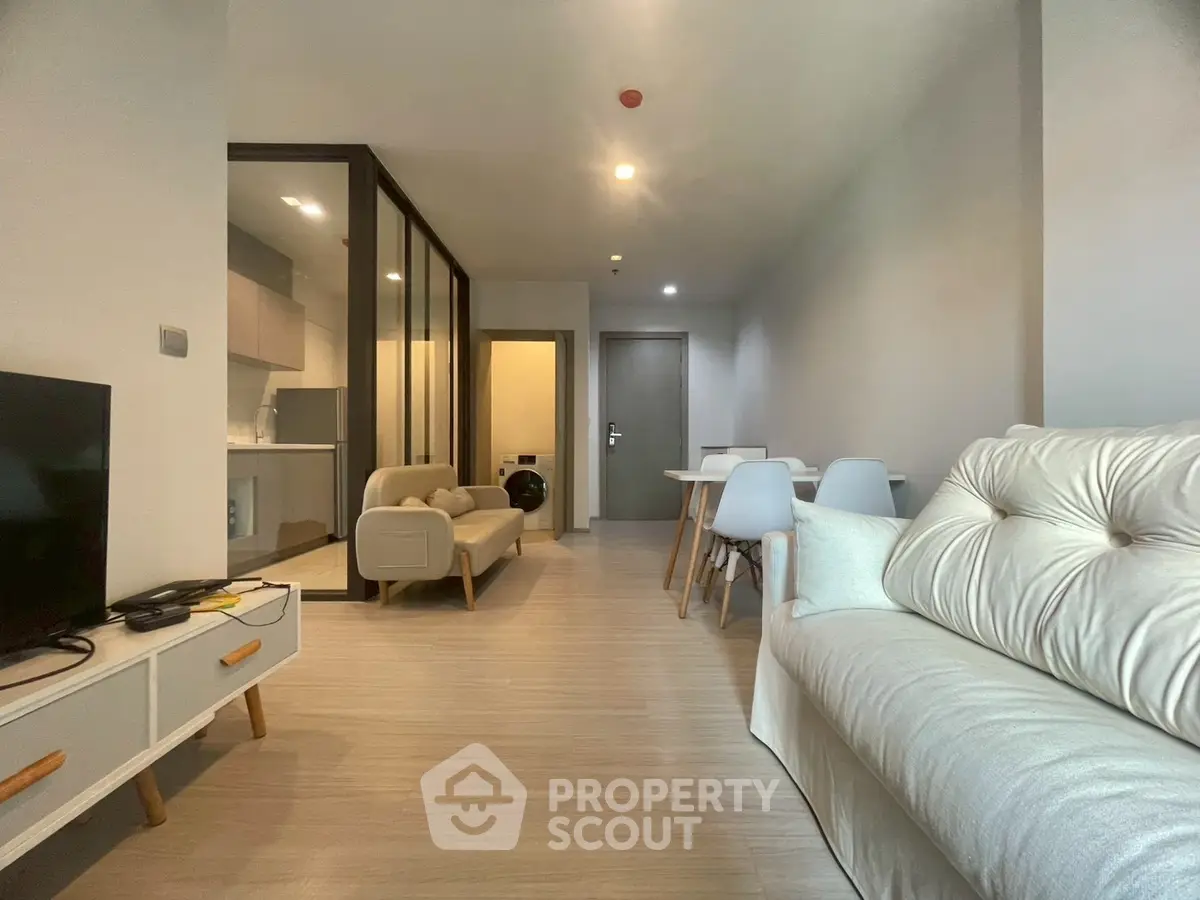 Modern living room with cozy seating and dining area in open layout apartment