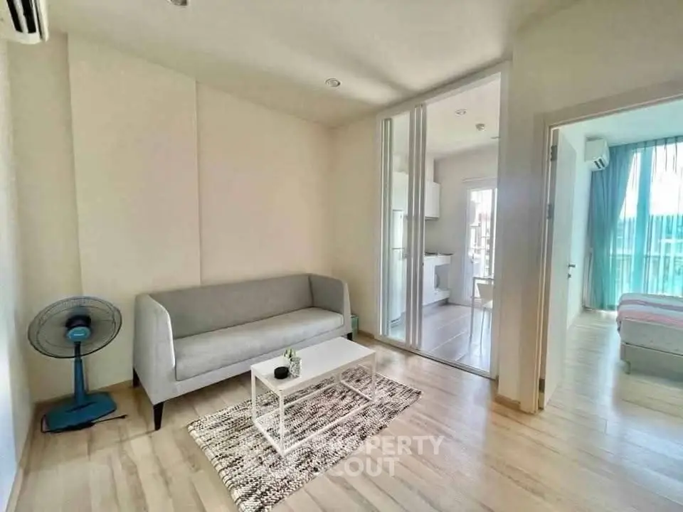 Modern living room with sleek design and natural light, featuring a cozy sofa and stylish decor.