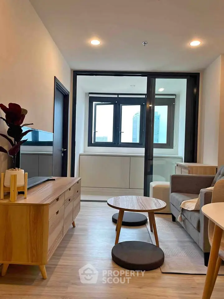 Modern living room with stylish furniture and large windows in a contemporary apartment.