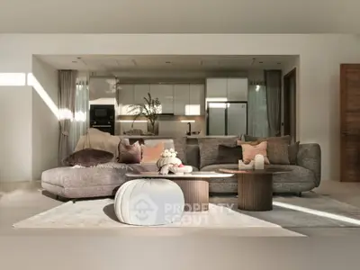 Luxurious open-layout living room with modern kitchen, plush sofa, and elegant decor.
