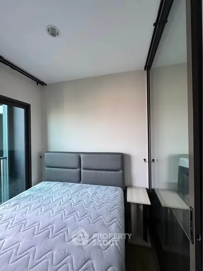 Modern bedroom with glass walls and balcony access