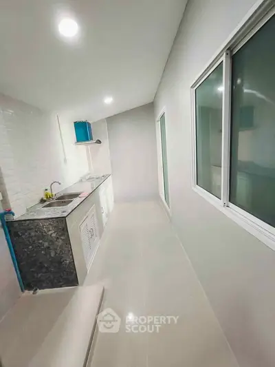 Modern kitchen with sleek countertops and ample natural light