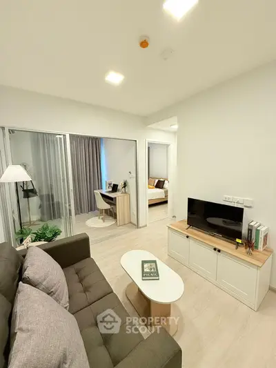 Modern living room with cozy sofa and stylish decor in open layout apartment.