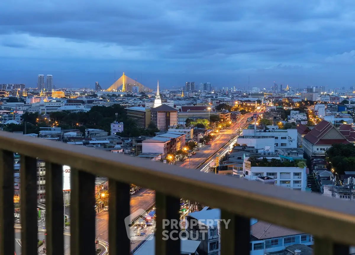 Stunning cityscape view from a high-rise balcony at dusk, showcasing vibrant city lights and skyline.