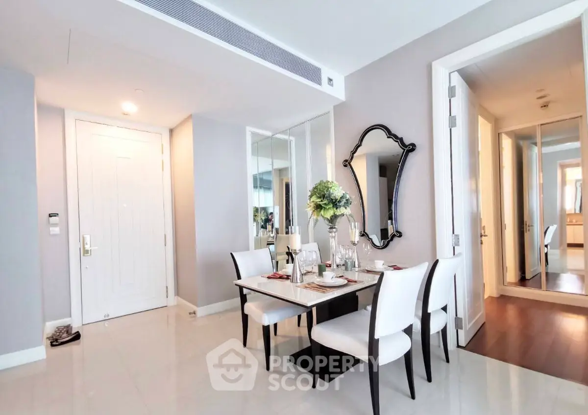 Elegant dining area with modern decor and stylish mirror in a luxurious apartment.
