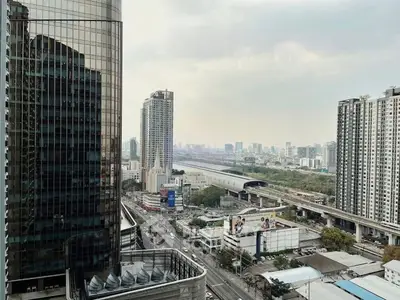 Stunning cityscape view from high-rise building showcasing urban skyline and transportation hub.