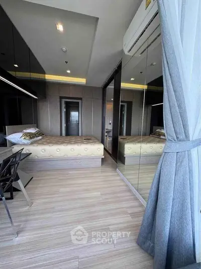 Modern bedroom with mirrored wardrobe and elegant decor