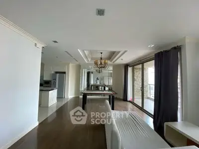 Spacious modern living room with elegant chandelier and large windows