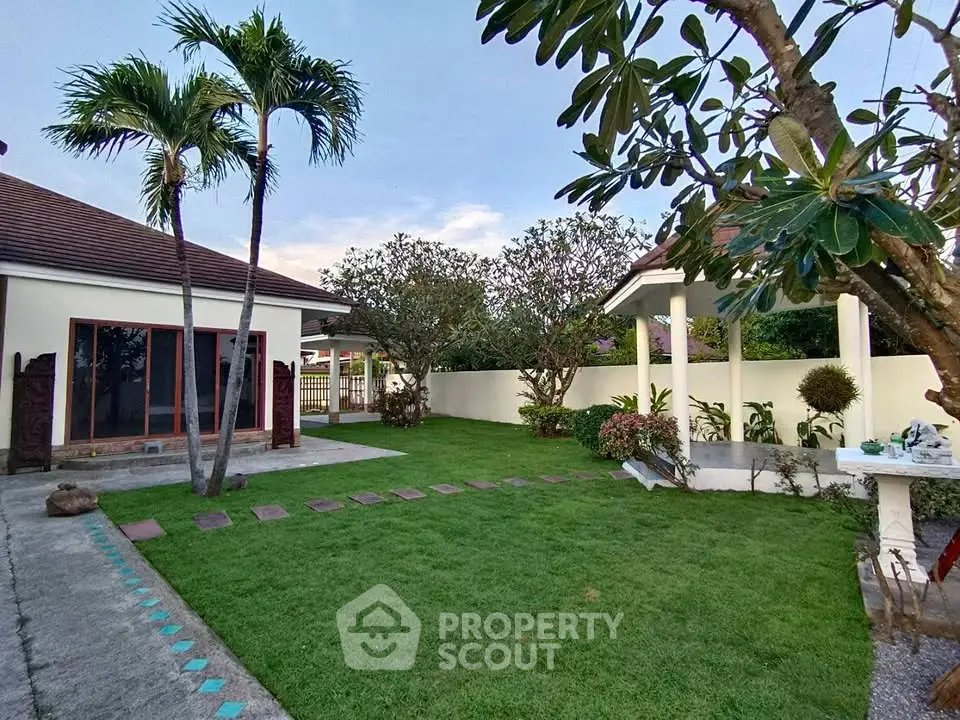 Charming garden view with lush greenery and cozy outdoor seating area.