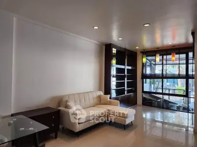 Spacious living room with modern sofa and large windows for natural light.