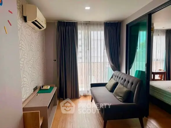 Modern living room with stylish sofa and large window in a cozy apartment.