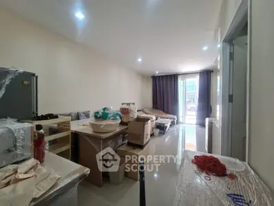 Spacious living room with modern furnishings and natural light, ideal for comfortable living.