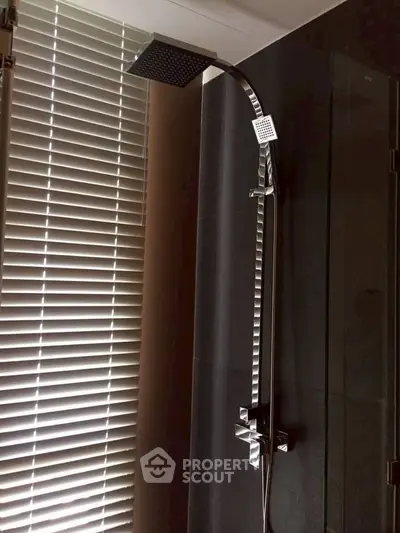 Modern bathroom with sleek showerhead and stylish blinds