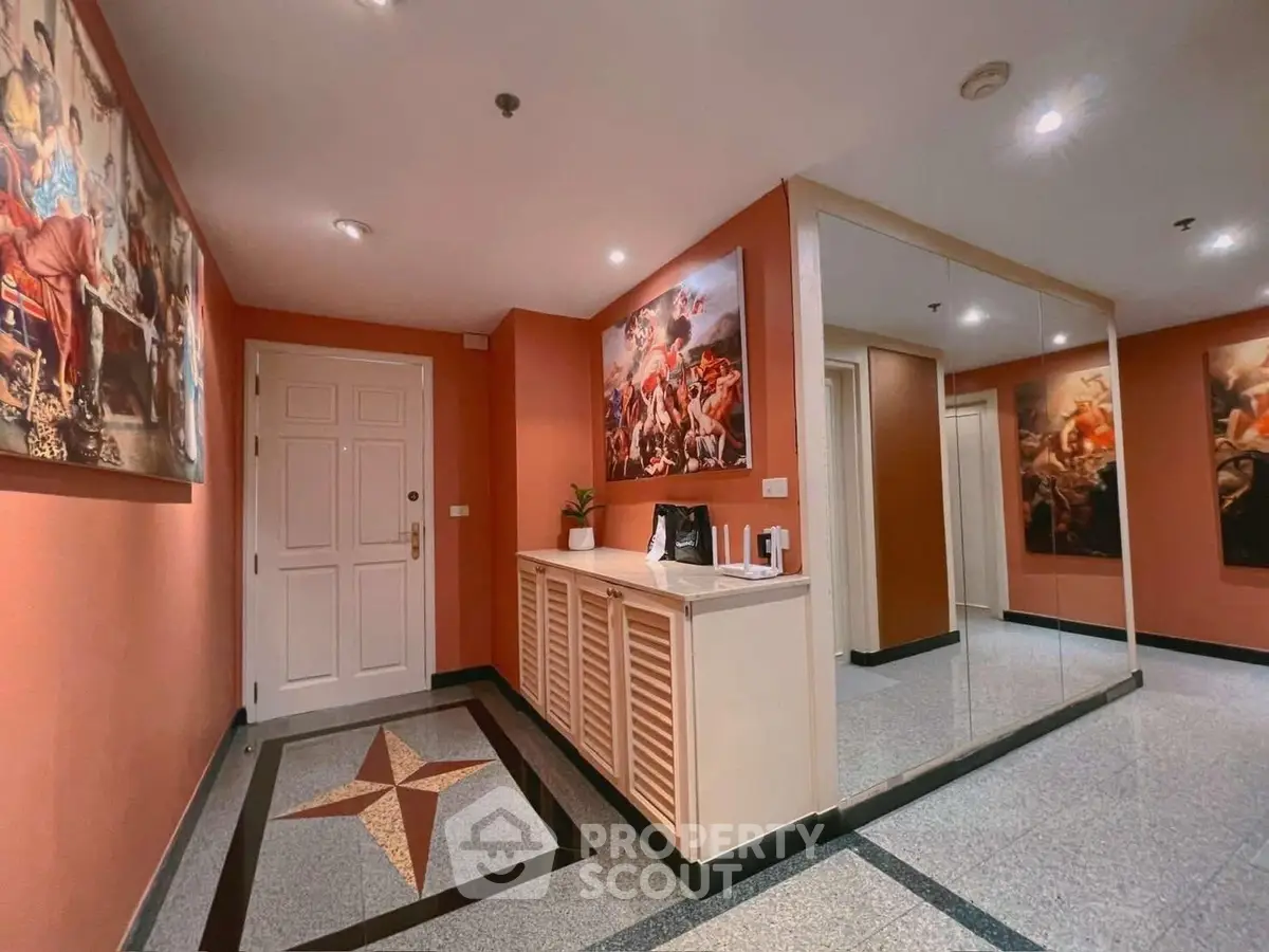 Elegant apartment entrance with art decor and large mirror