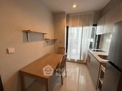 Cozy kitchen with modern appliances and dining area in a stylish apartment.