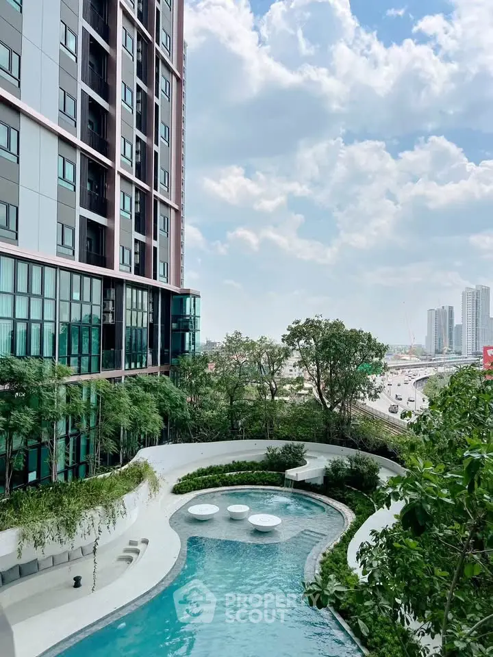 Luxurious high-rise building with stunning pool and city view, perfect for urban living.