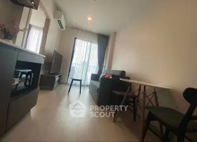Modern living room with sleek furniture and natural light in a cozy apartment.