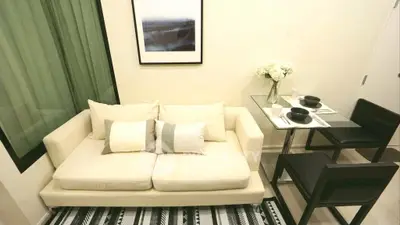 Chic modern living room with cozy sofa and elegant dining area, perfect for urban living.