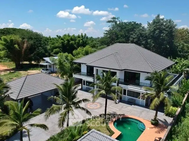 Stunning tropical villa with pool and lush greenery, perfect for luxury living.
