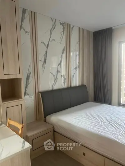 Modern bedroom with stylish marble accent wall and wooden furniture, featuring a cozy bed and natural light.