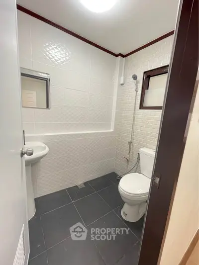 Modern bathroom with sleek white tiles and compact design