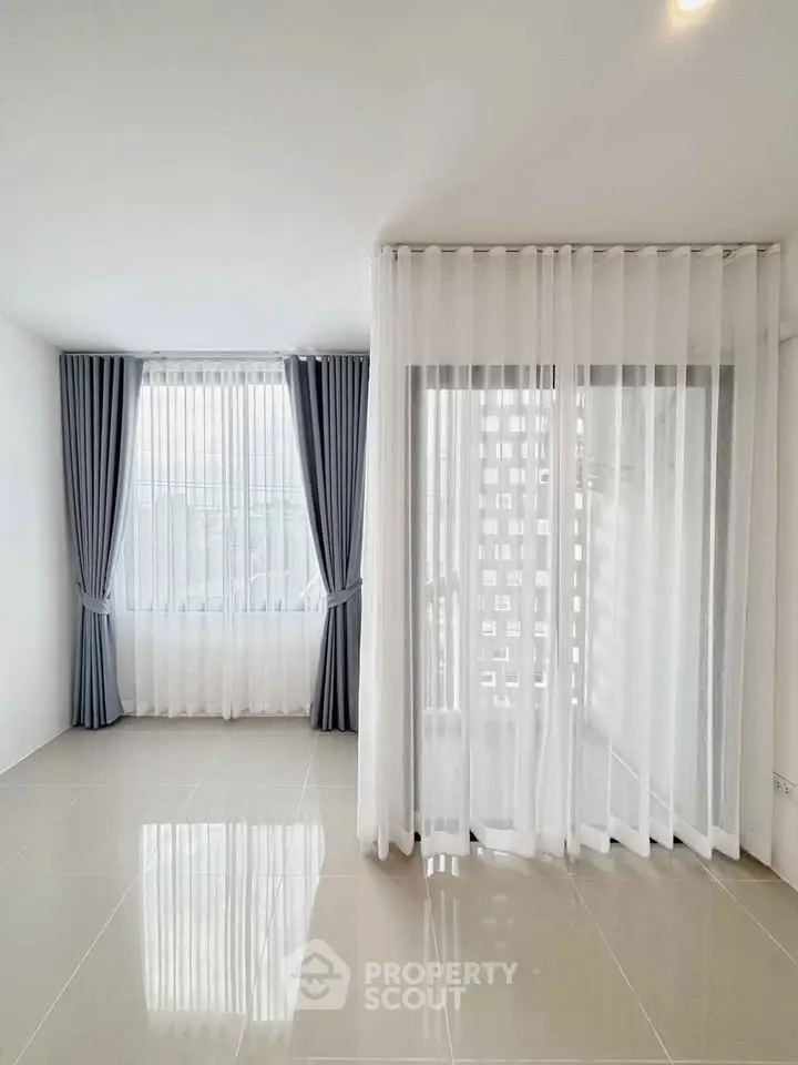 Bright and airy living room with large windows and elegant curtains