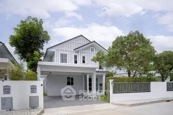 Charming modern two-story house with a spacious driveway and lush greenery, perfect for family living.