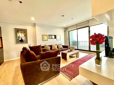 Spacious living room with modern decor and large windows for natural light.