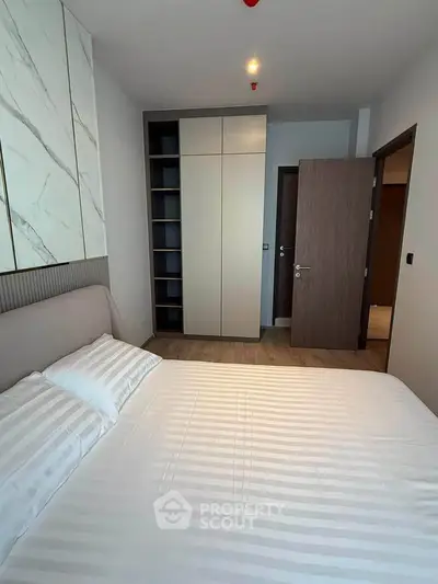Modern bedroom with stylish decor and built-in wardrobe