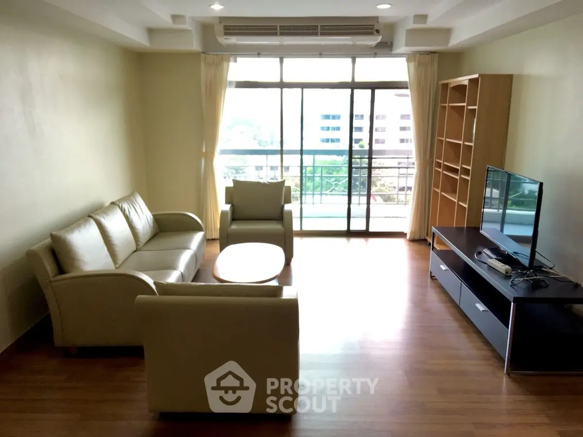 Spacious living room with modern furniture and large window view