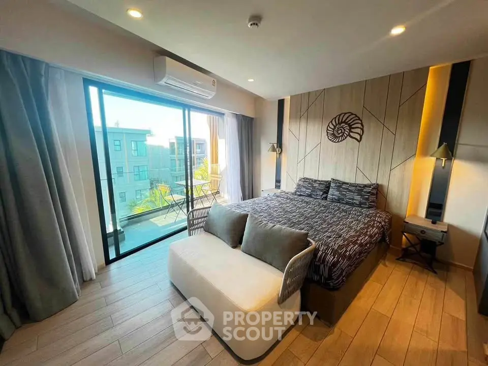 Luxurious bedroom with balcony and modern decor in a high-rise apartment.