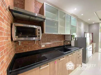 Modern kitchen with sleek cabinets and built-in appliances in stylish apartment