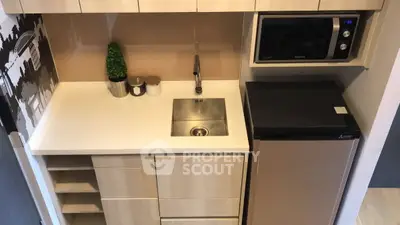 Compact modern kitchen with sleek cabinetry and built-in appliances