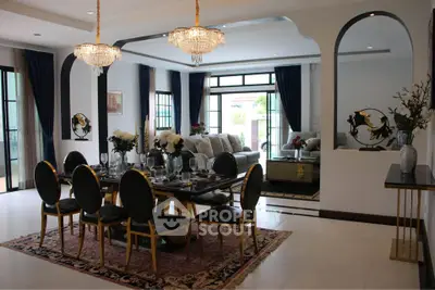 Luxurious dining and living area with elegant decor and chandeliers