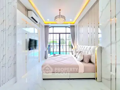 Luxurious bedroom with elegant decor and large windows offering natural light.