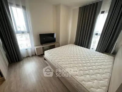 Modern bedroom with large windows and stylish curtains, featuring a comfortable bed and sleek TV stand.