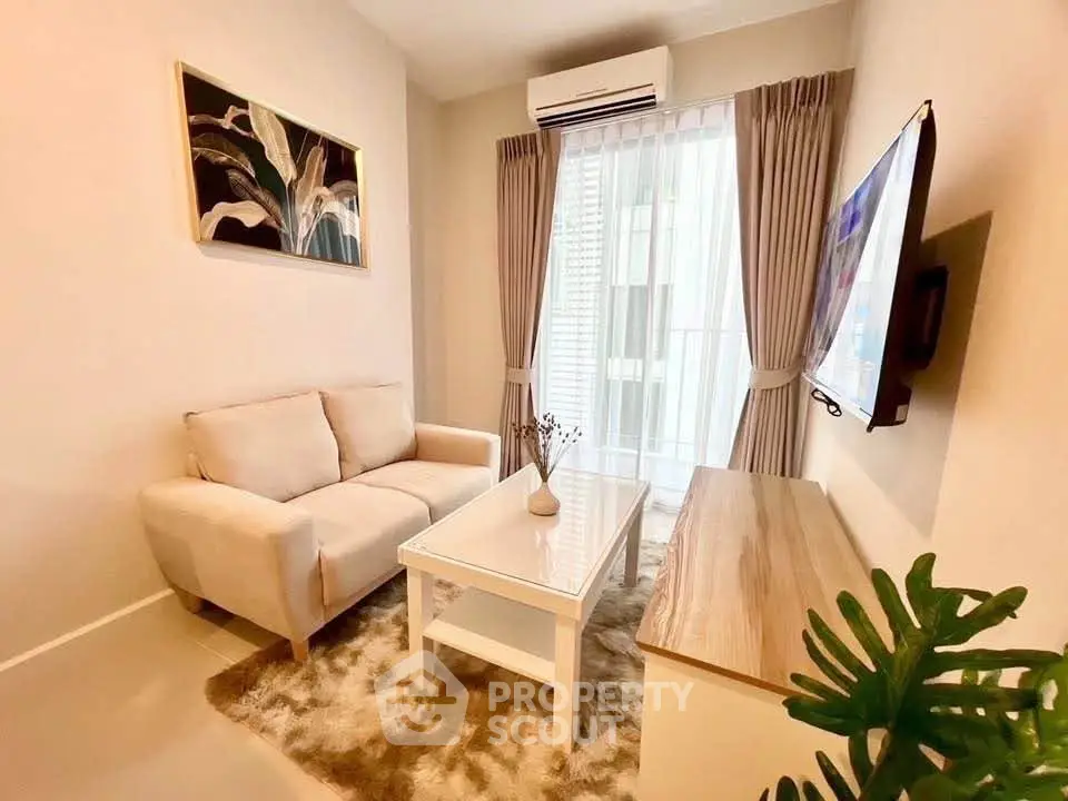 Cozy living room with modern decor, plush sofa, and wall-mounted TV, perfect for relaxation.