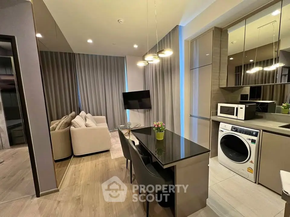 Modern open-layout living room with sleek kitchen and stylish furniture