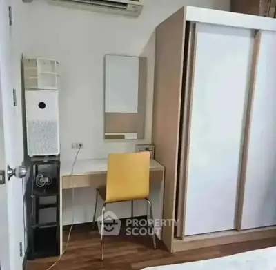 Modern study area with desk, chair, and wardrobe in a stylish apartment.
