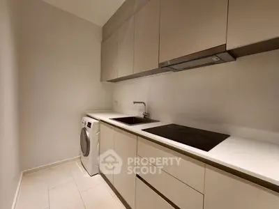 Modern kitchen with sleek cabinetry and built-in appliances