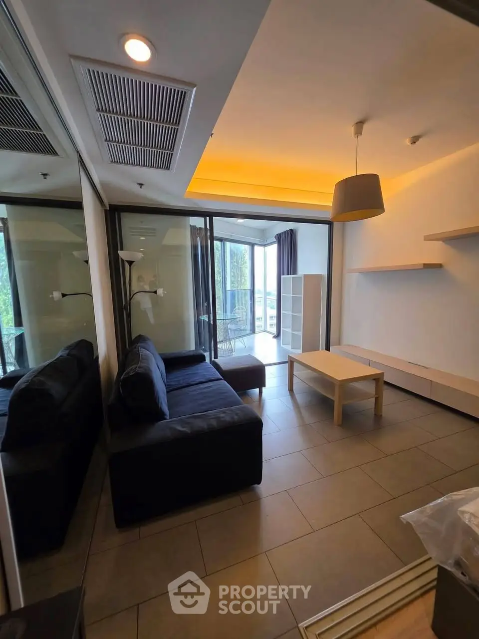 Modern living room with sleek furniture and balcony access