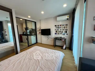 Modern bedroom with sleek design, featuring a wall-mounted TV, air conditioning, and a cozy bed.