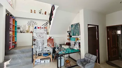 Spacious modern living area with unique decor and open staircase