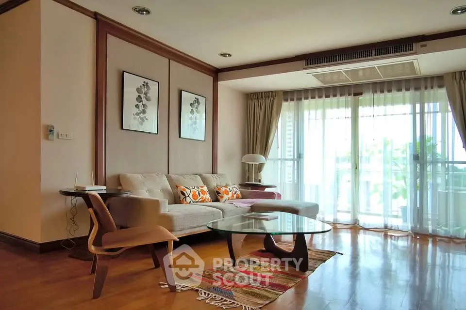 Spacious living room with modern decor and large windows offering natural light.