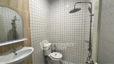 Modern bathroom with sleek shower and white tile design