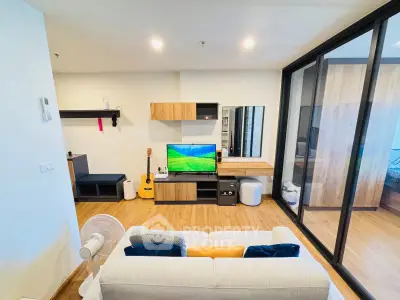 Modern living room with stylish decor and entertainment center in a cozy apartment.