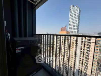 High-rise balcony with washing machine and city view
